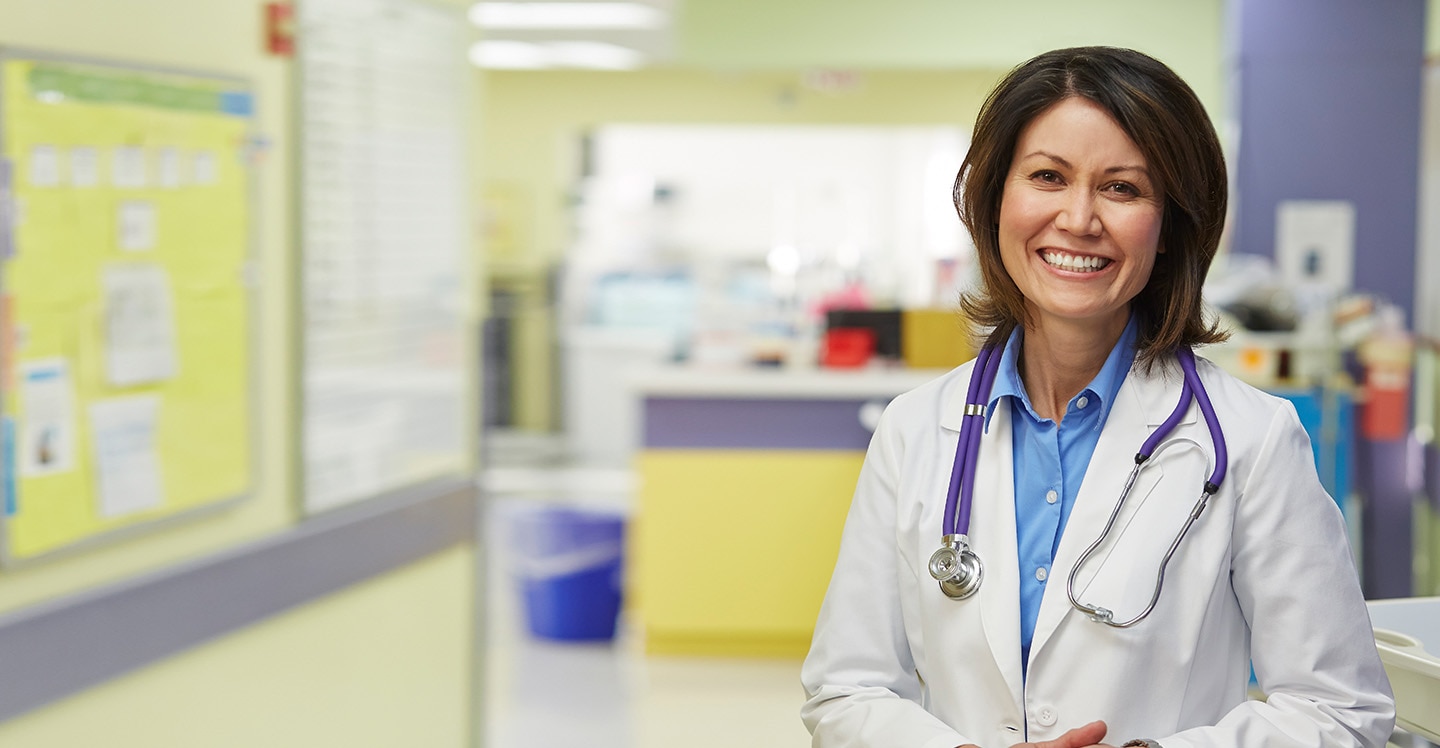 Children's female physician standing in hospital
