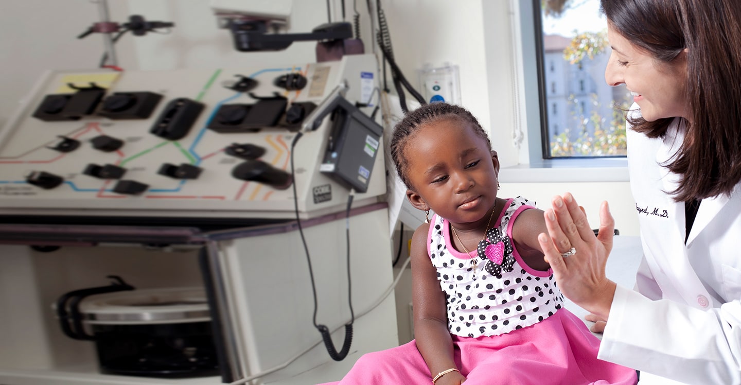 young girl sickle cell patient giving her doctor a high five