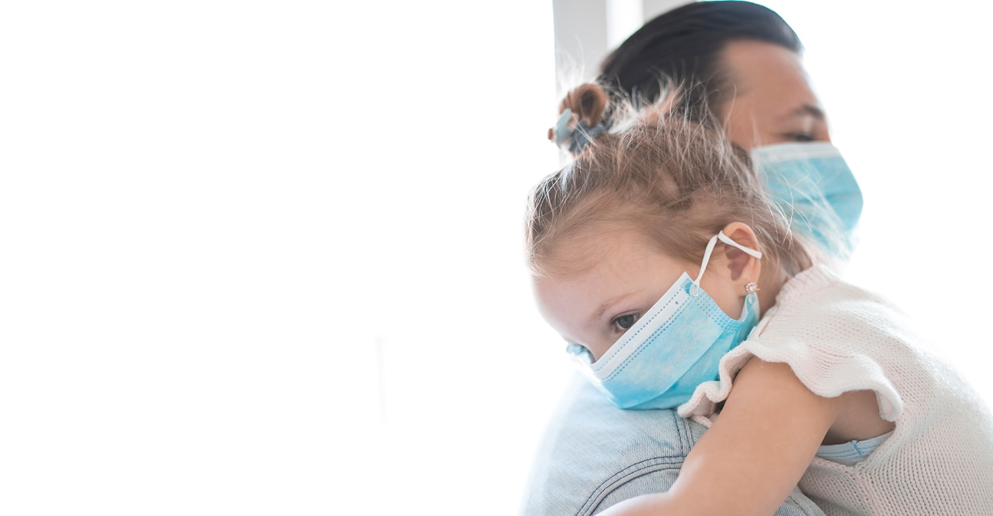 Dad and daughter wearing masks for pediatric care